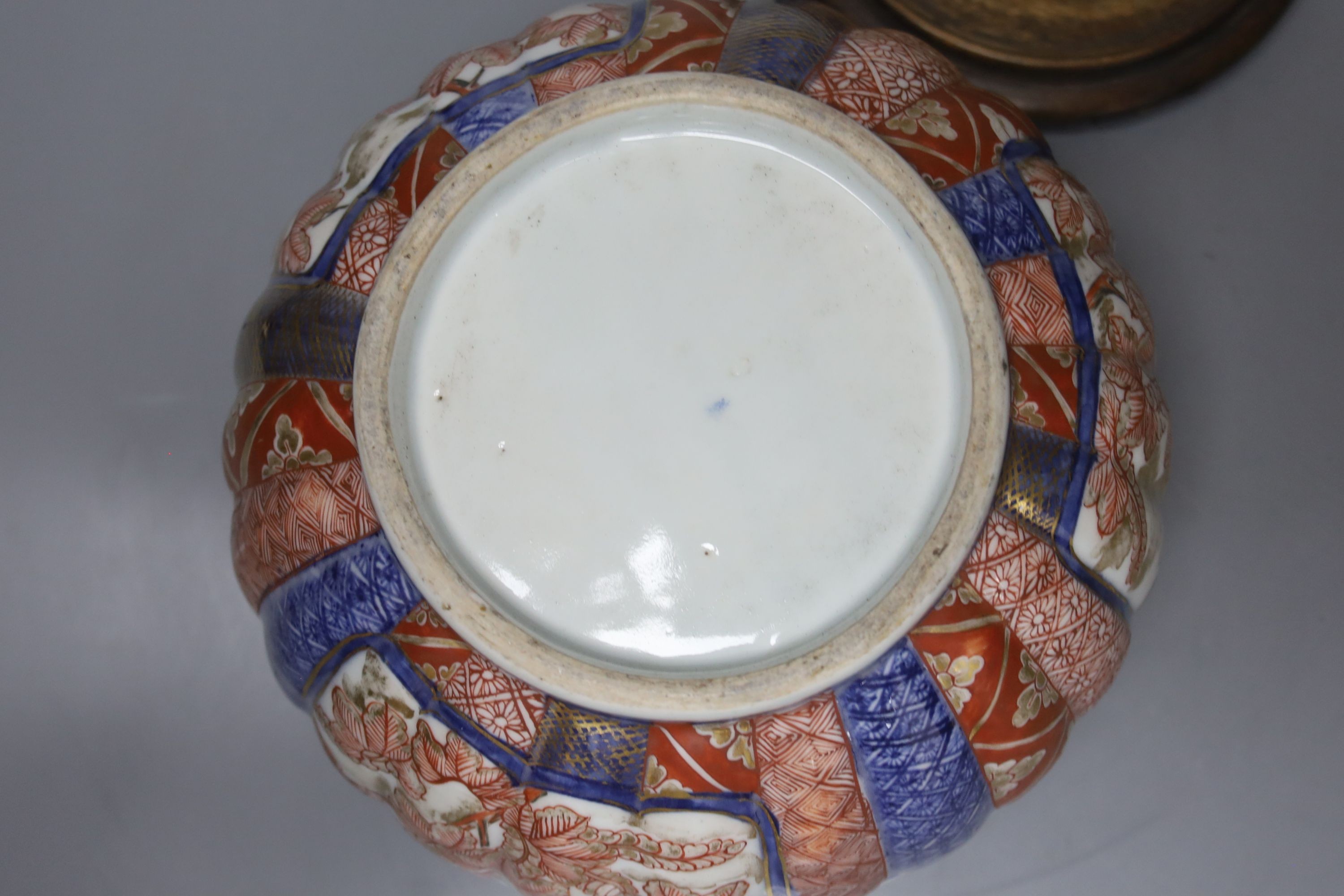 A 19th century Japanese Imari box and cover and a Satsuma pottery figure of a boy holding a Daruma doll, tallest 20cm